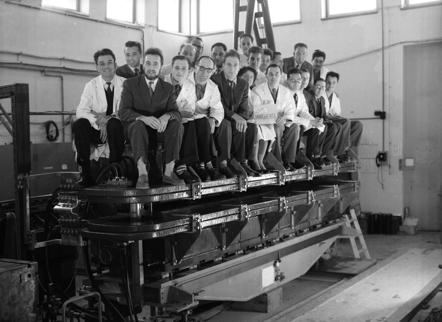 People sitting on top of a large magnet
