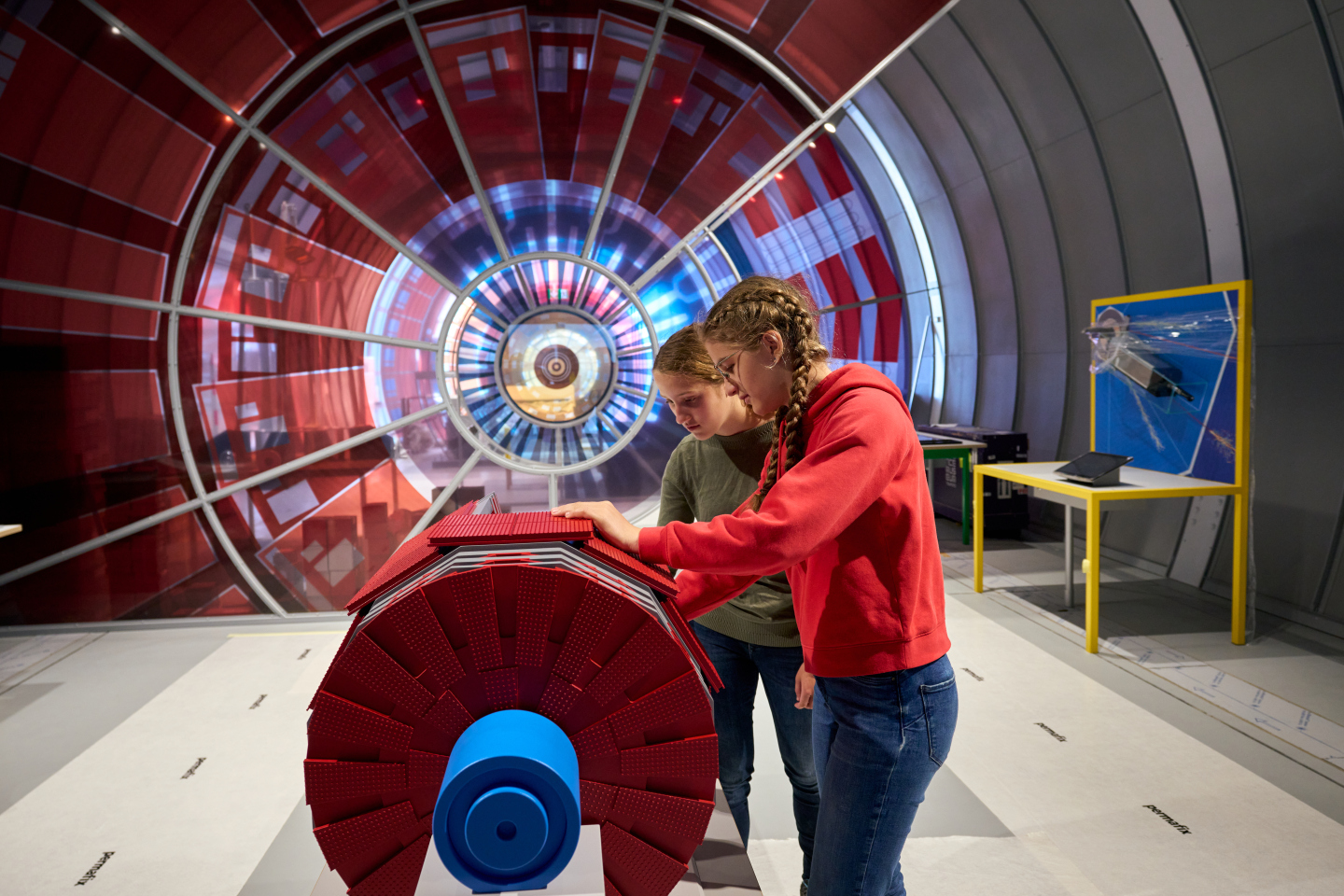 Children visiting Science Gateway’s Collide exhibition. This model detector is tactile to allow visitors with visual impairments to discover the detector’s components. (Image: CERN)