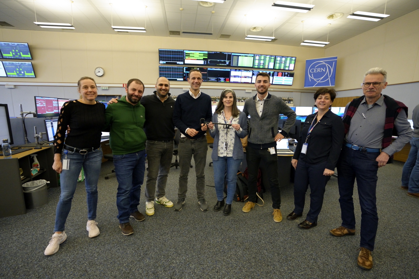 Members of CERN's Operations and ACE groups hold the symbolic LHC key 