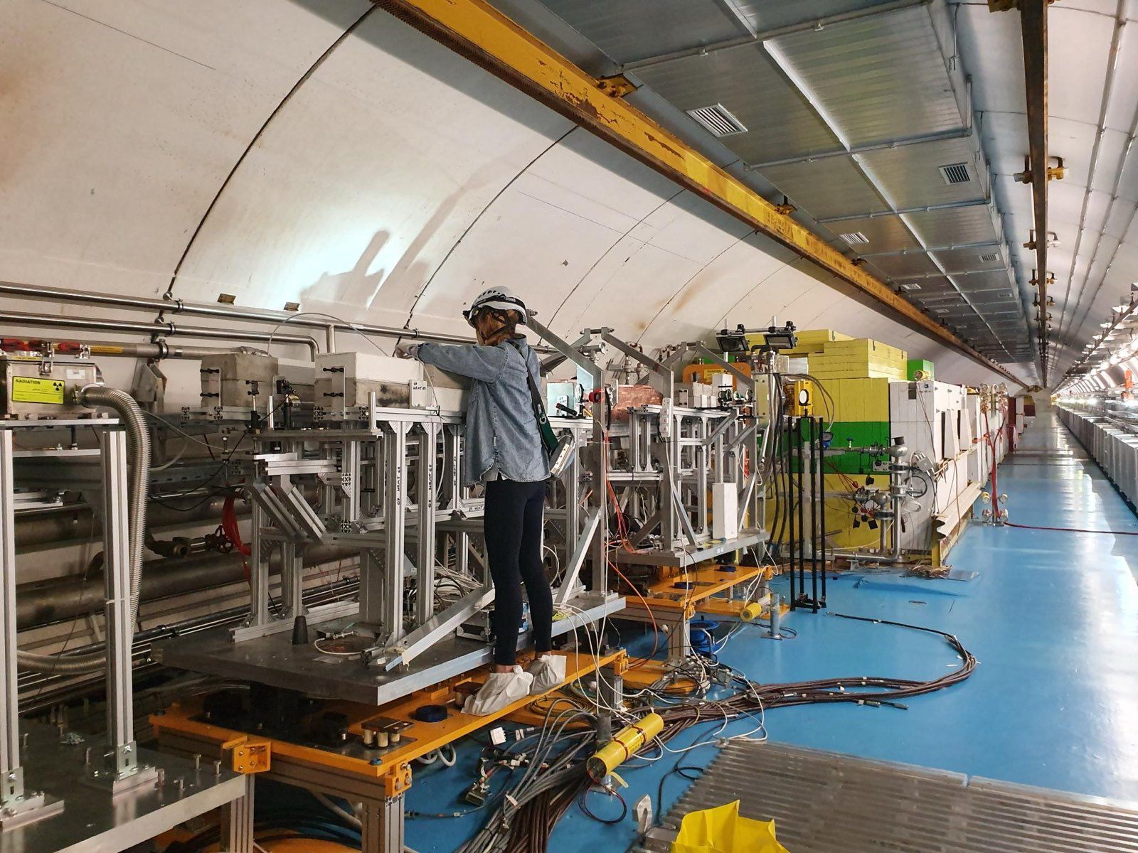 A woman in front of machinery inside the SPS tunnel